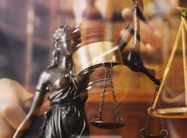 Scales of justice and gavel in a courtroom